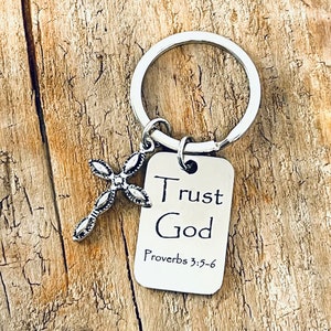 May include: Silver keychain with a cross charm and a rectangular tag that reads "Trust God Proverbs 3:5-6".