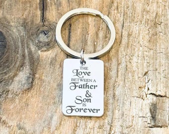 May include: Silver keyring with a rectangular tag that reads "The love between a father & son is forever".