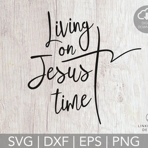 May include: Black text on a light wood grain background reads "Living on Jesus time" with a cross graphic. Includes a digital download icon and file type options: SVG, DXF, EPS, and PNG.