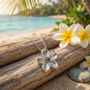 May include: A silver-toned necklace featuring a five-petaled flower pendant with a smooth, reflective surface. The pendant is attached to a delicate box chain, creating a simple and clean design that highlights the metallic finish of the piece.