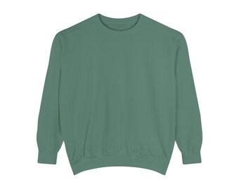 May include: A solid, sage green sweatshirt with a crew neck and long sleeves. The garment is made of a soft material and has a relaxed fit. The cuffs and hem are ribbed. This casual top is suitable for everyday wear.