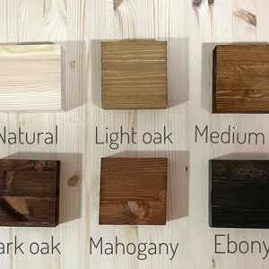 May include: Six wood samples showing different wood stain colours: natural, light oak, medium oak, dark oak, mahogany, and ebony.