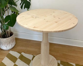 Round dining table with pedestal leg. handmade solid wood cafe table, natural, light , single leg, center support table.