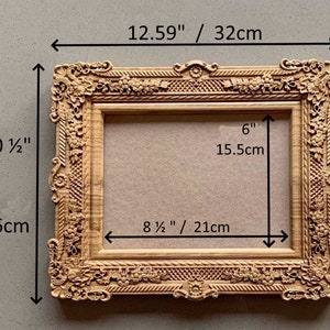 May include: A wooden picture frame with ornate carvings and a light brown finish. The frame measures 12.59 inches wide by 10 1/2 inches tall and has an interior opening of 8 1/2 inches wide by 6 inches tall.