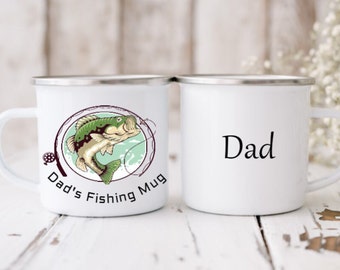 May include: Two white enamel mugs with a black rim. One mug has a green and brown illustration of a fish with the text "Dad's Fishing Mug". The other mug has the text "Dad" on it.