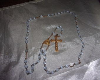 Old rosary in blue glass bead and gold metal