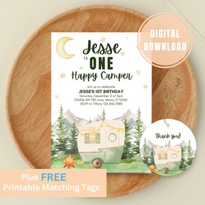 May include: A digital download invitation for a first birthday party with a camping theme. The invitation features a watercolor illustration of a camper van in a forest setting with mountains in the background. The text on the invitation reads "Jesse is One Happy Camper".