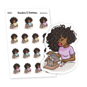 May include: A sheet of stickers featuring a Black woman decorating a gingerbread house. The woman has curly black hair and is wearing a pink shirt. The stickers are arranged in a grid pattern. The text "Vaalea & Tumma" is at the top of the sheet.