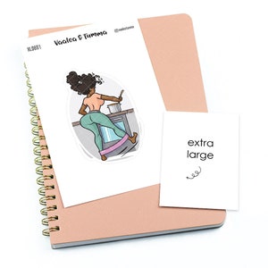 May include: A sticker featuring a cartoon illustration of a woman of color wearing a green outfit and using a resistance band while cooking on a stove. The sticker is on a white background and says "Vaalea & Tumma" and "XL0801". The sticker is next to a white card that says "extra large" with a squiggly line underneath.