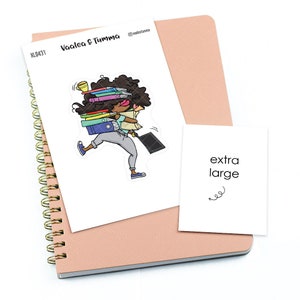 May include: A sticker of a cartoon woman carrying a stack of books, a laptop, and a cup of coffee. The sticker is on a white background and says "Vaalea & Tumma" and "extra large".