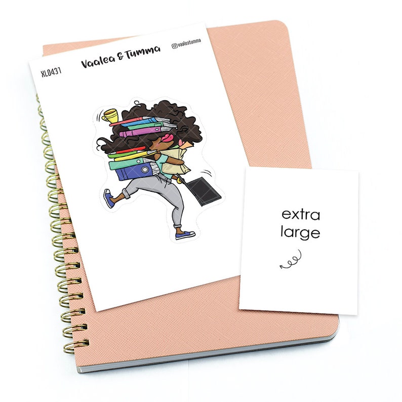 May include: A sticker of a cartoon woman carrying a stack of books, a laptop, and a cup of coffee. The sticker is on a white background and says "Vaalea & Tumma" and "extra large".