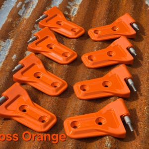 May include: Eight gloss orange metal hinges with two circular screw holes each and a silver-toned pin. The hinges are arranged in two columns. The text "Gloss Orange" is printed in the bottom left corner of the image.