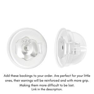 May include: Two clear plastic earring backs with a silver 925 stamp on the back.