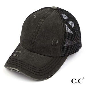 May include: A distressed black baseball cap with a curved brim and a mesh back. The cap has a worn appearance with small tears and a faded look. The brand logo "C.C." is visible on the right side.