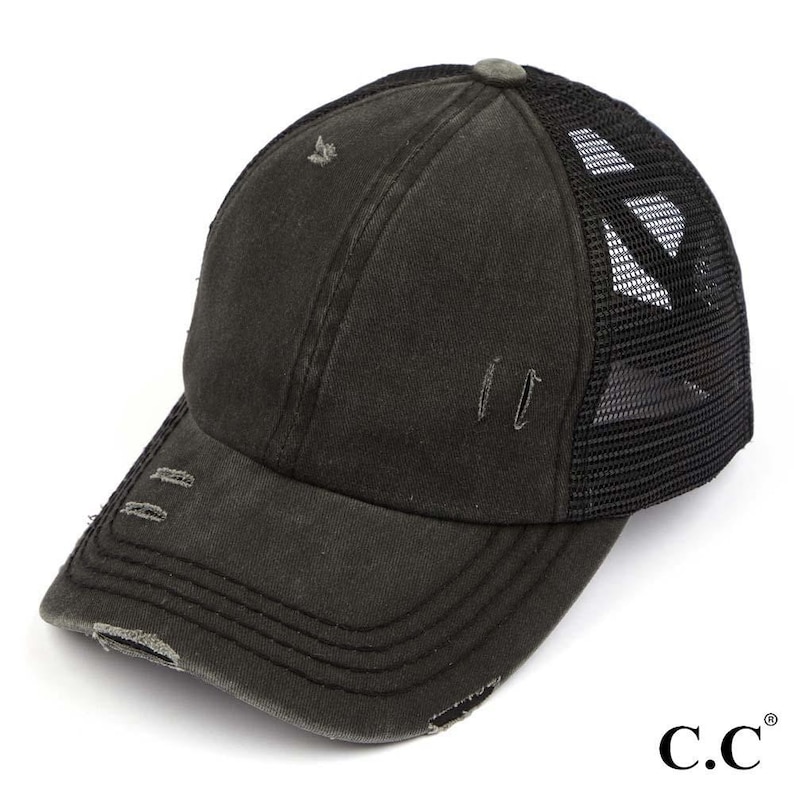 May include: A distressed black baseball cap with a curved brim and a mesh back. The cap has a worn appearance with small tears and a faded look. The brand logo "C.C." is visible on the right side.
