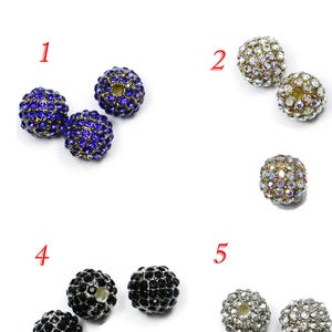 May include: Nine different colors of round, sparkly beads. Each bead is covered in small rhinestones. The beads are arranged in rows of three, with numbers 1 through 9 labeling each row.