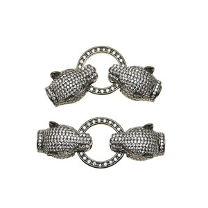 May include: Two silver-toned, animal-shaped clasps with a circle of clear stones in the center. The clasps are connected by a silver-toned chain.