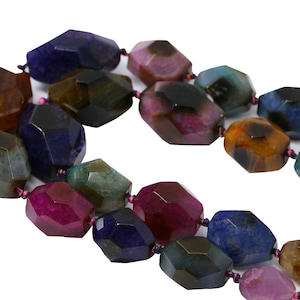 May include: A strand of multi-colored agate gemstone beads. The beads are faceted and have a variety of colors, including brown, green, blue, purple, and pink.