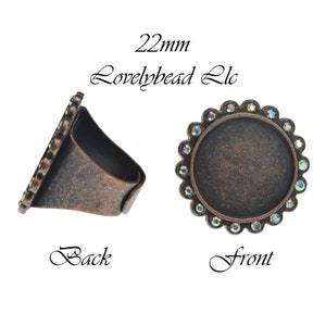 May include: A 22mm copper ring setting with a round bezel and a row of iridescent rhinestones around the edge. The ring is shown from the front and back.