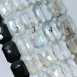May include: Five rows of faceted glass beads, numbered 1 through 5. The first bead is black, the rest are clear with varying degrees of translucence.