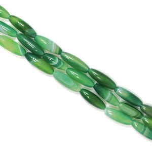 May include: A strand of elongated, oval-shaped green agate beads. The beads feature a smooth, polished finish with natural banded patterns in varying shades of emerald, lime, and forest green, interspersed with thin, translucent white lines.