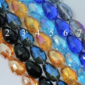 May include: Seven teardrop-shaped glass beads in various colors, including black, gold, blue, and teal. The beads are numbered 1 through 7.