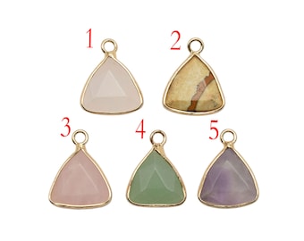 May include: Five gold triangle pendants with different colored stones. The stones are pink, beige, light pink, green, and purple.