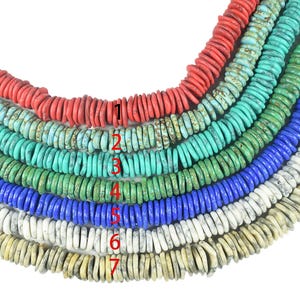 May include: Seven strands of flat, disc-shaped beads arranged in a curved pattern. The strands are colored red, turquoise, light blue, green, blue, white with grey veining, and tan with grey veining. Each strand is numbered from one to seven.