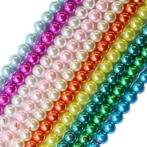May include: Ten strands of round, iridescent pearls in various colors, including light blue, pink, white, orange, yellow, teal, and green. The pearls are arranged in rows, with each row a different color.