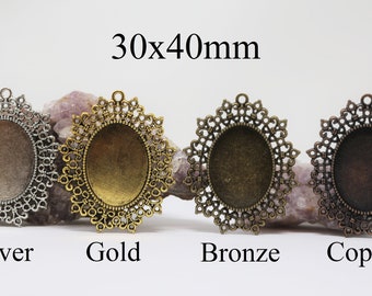 May include: Four oval-shaped metal pendant trays with a filigree design. The trays are 30x40mm and are available in silver, gold, bronze, and copper.