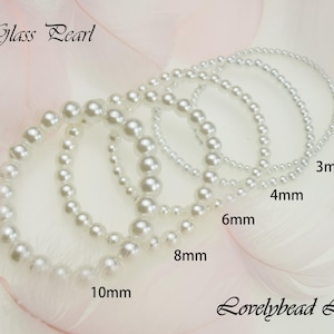 May include: Glass pearl strands in various sizes, from 3mm to 10mm, displayed on a white background. The pearls are white and round. The text "Glass Pearl" and "Lovelybead LLC" are visible in the image.
