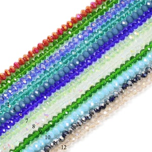 May include: Twelve strands of faceted glass beads in various colors, including red, green, blue, and clear. The beads are arranged in a rainbow pattern.