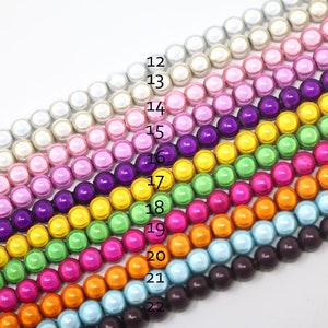 May include: A rainbow assortment of round, iridescent beads, arranged in rows, with numbers 12 through 22 listed on the right side of the image.