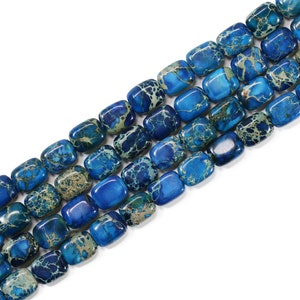 May include: A strand of blue and white patterned gemstone beads. The beads are rectangular and have a smooth, polished finish.