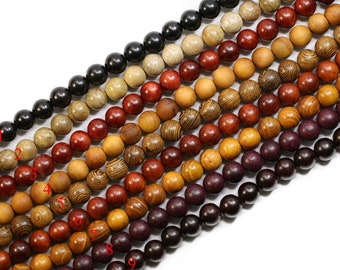 May include: A strand of wooden beads in various shades of brown, red, and purple. The beads are arranged in rows, with the darkest beads at the bottom and the lightest beads at the top.