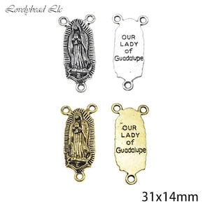 May include: Two silver and two gold-toned Our Lady of Guadalupe charms with three jump rings. The charms are rectangular with a rounded top and bottom. The charms measure 31 mm by 14 mm.