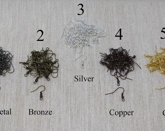May include: Five piles of earring hooks in different colors: gunmetal, bronze, silver, copper, and gold. Each pile is labeled with a number 1 through 5. The silver pile is labeled "Silver". The gunmetal pile is labeled "Gunmetal". The bronze pile is labeled "Bronze". The copper pile is labeled "Copper". The gold pile is labeled "Gold".