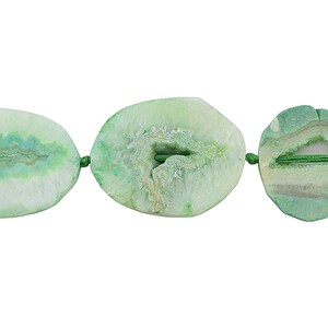 May include: Three green agate beads with a white center and green veins. The beads are strung on a green cord.