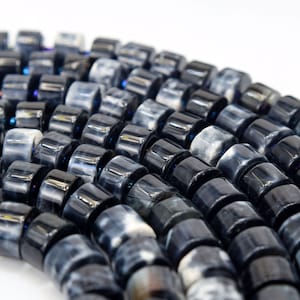 May include: A strand of black and white agate beads. The beads are round and have a smooth, polished finish.