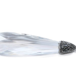 May include: A clear crystal teardrop pendant with a silver bail and a black rhinestone-encrusted cap.