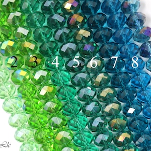 May include: A strand of faceted glass beads in shades of green and blue. The beads are arranged in a gradient from light green to dark blue. The beads are numbered 1 through 9.