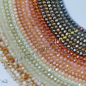 May include: A close-up of 20 strands of faceted glass beads in various colors, ranging from white to dark gray. The beads are arranged in a semi-circle, with the numbers 1 through 20 printed below each strand.