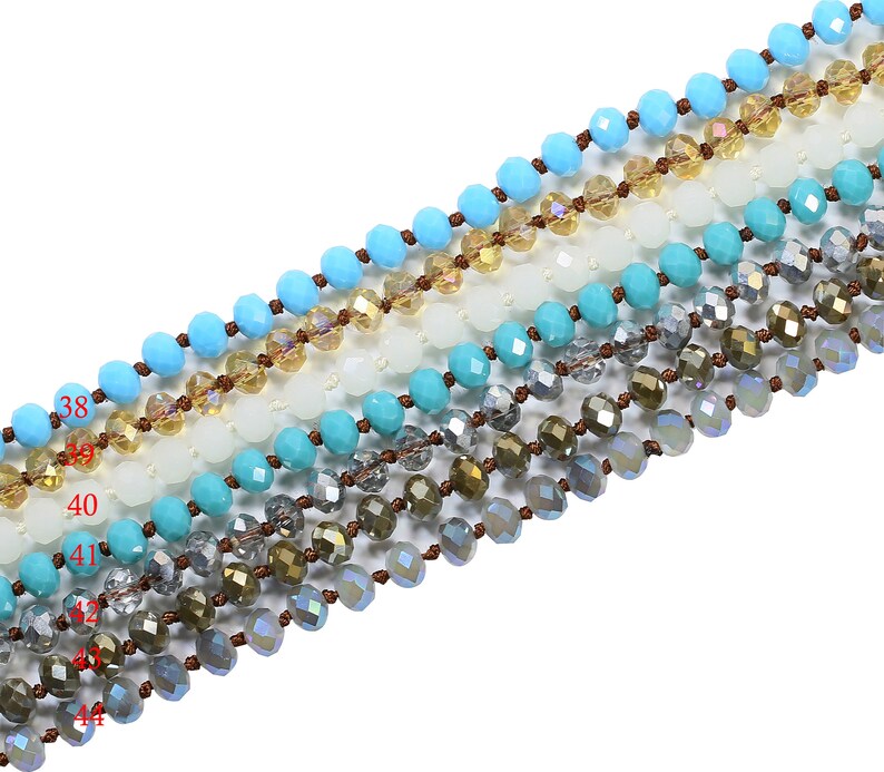 May include: A strand of turquoise blue, white, and clear faceted glass beads with brown string.