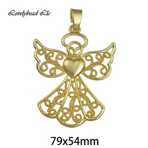 May include: Gold filigree angel pendant with a heart in the center. The pendant measures 79x54mm.