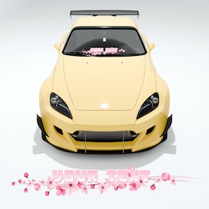 以下が含まれることがあります： 黒いスポイラーと黒いホイールを備えた黄色のスポーツカー。車は黒いフロントバンパーと黒いグリルを備えています。車はフロントガラスにピンクの花のデザインが施されています。