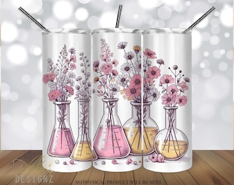 May include: Three stainless steel tumblers with a white background and a design of pink and white flowers in glass beakers. The tumblers have lids and straws.