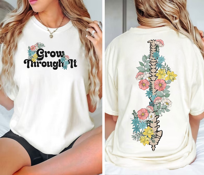 May include: White t-shirt with the text "Grow Through It" on the front and a floral design with a spine in the centre on the back.