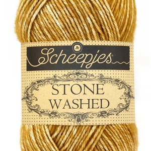 May include: A ball of Scheepjes Stone Washed yarn in a golden yellow color with white speckles.