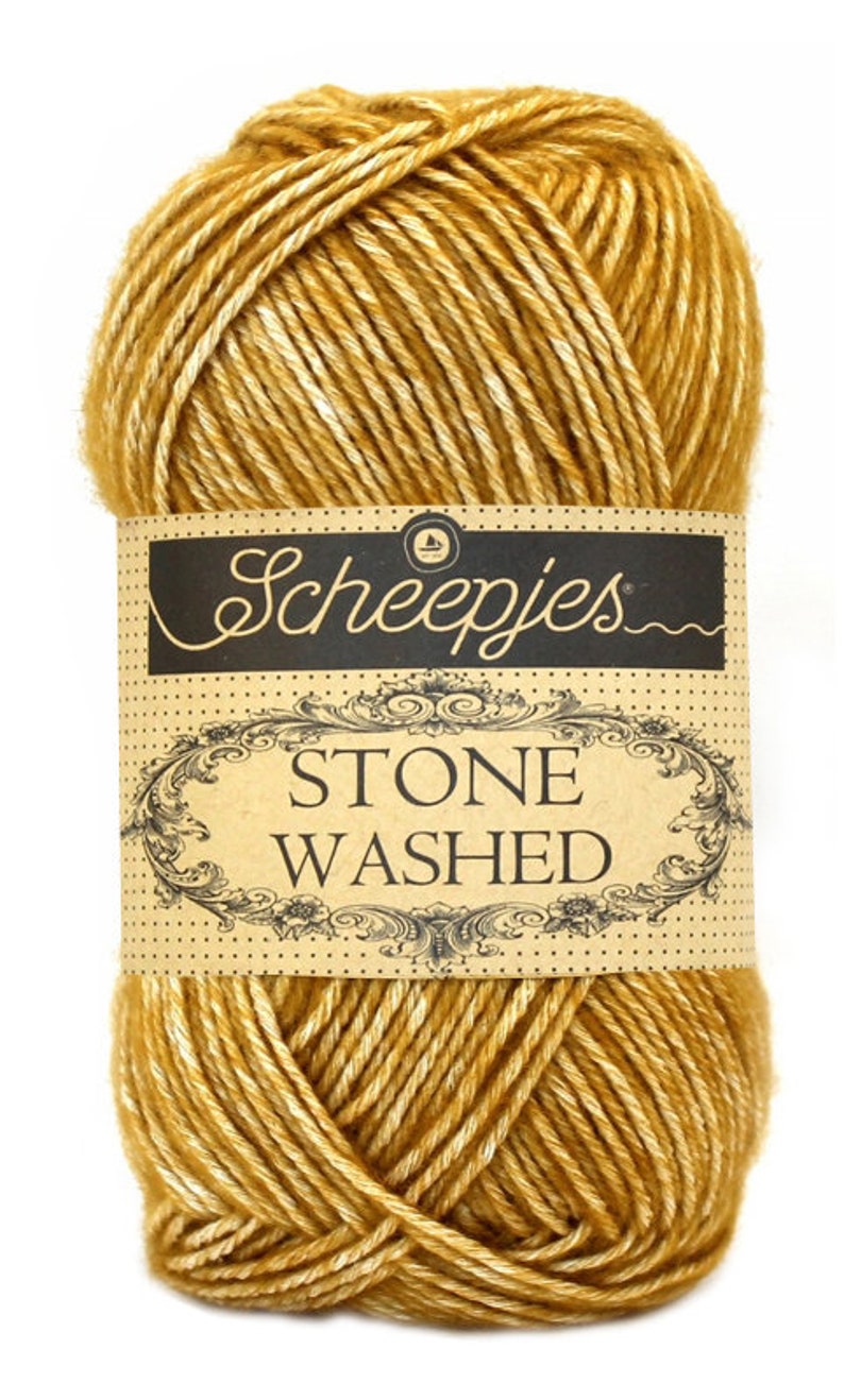 May include: A ball of Scheepjes Stone Washed yarn in a golden yellow color with white speckles.