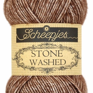 May include: A ball of brown and white yarn with a label that reads "Scheepjes Stone Washed."